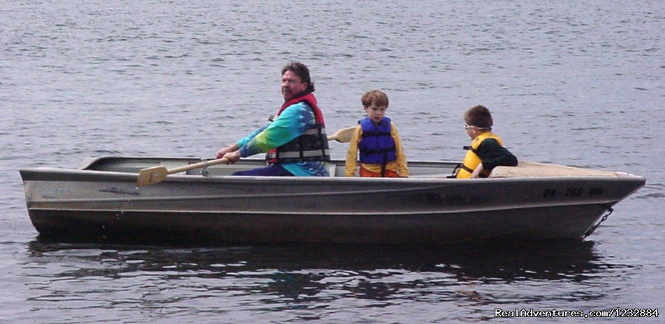 Family in row boat | Elegant Lakefront Vacation Rental | Image #8/10 | 