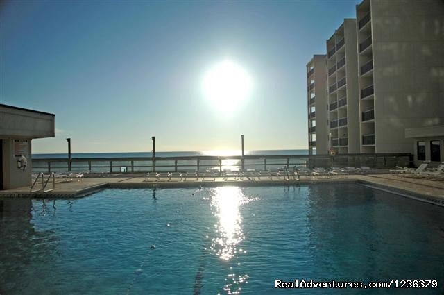 Sunsetting over the large 125,000 gallon pool. | Luxury Waterfront Condo on Panama City Beach | Image #8/11 | 