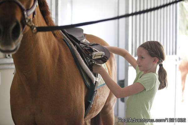 Student preparing for ride | Haile Plantation Equestrian Center | Image #7/7 | 